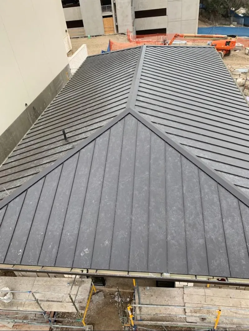 Commercial metal roof construction with crane equipment in Hartsville-Trousdale County