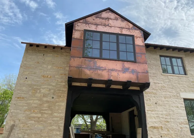 Copper metal panel facade on a stone building for Skylight Installation in Hartsville-Trousdale County