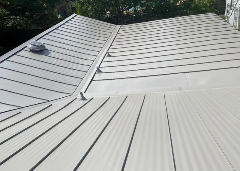 Solar attic fan installed on a metal roof for Roof Ventilation in Hartsville-Trousdale County